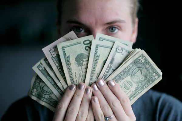 person holding USA cash